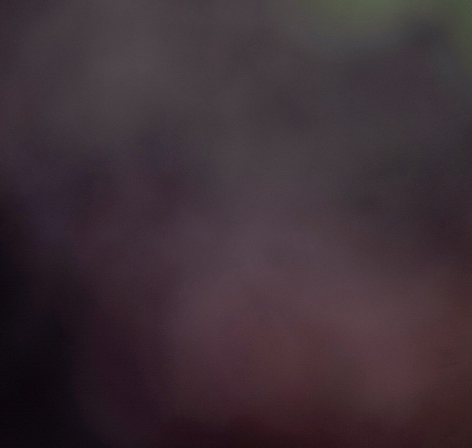 Blurred dark abstract background with muted purple and grey tones